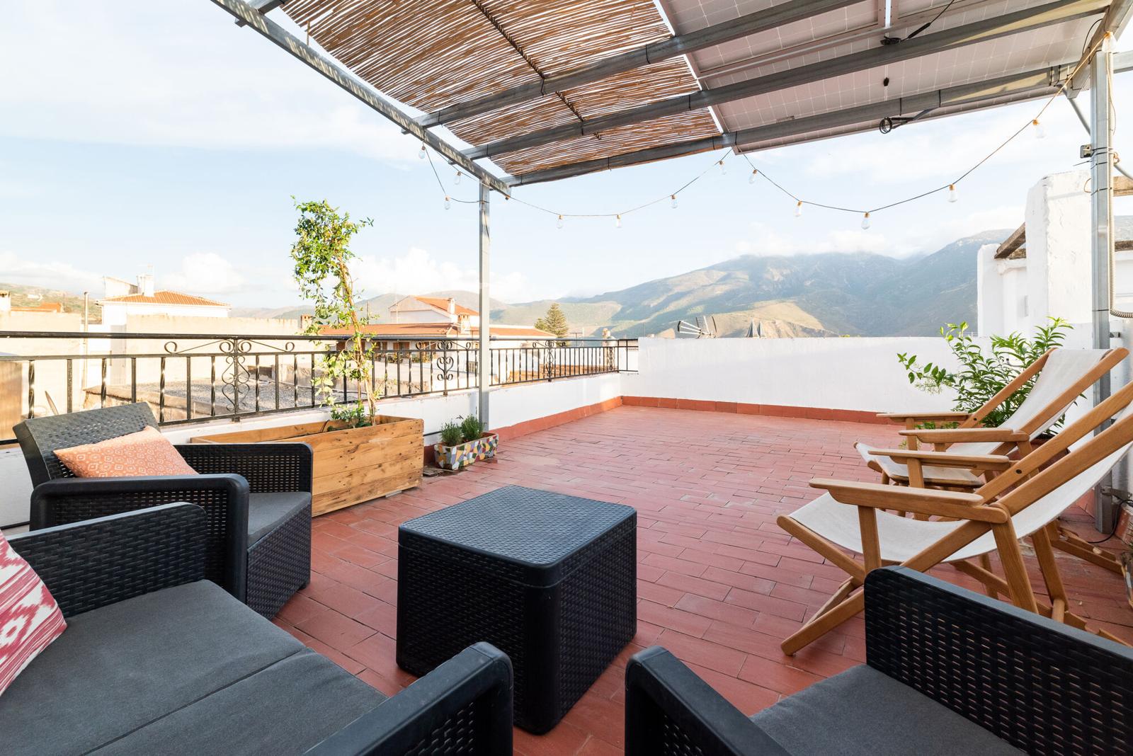 Rooftop terrace with sofas and a view of Sierra Nevada